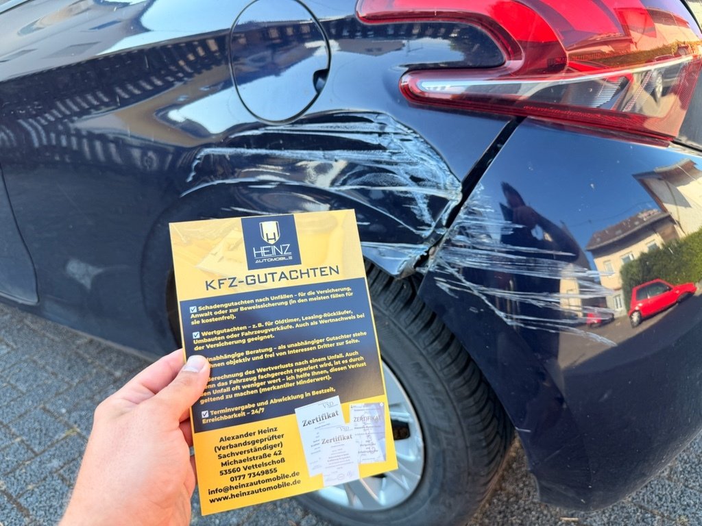 Flyer von Kfz-Gutachter Heinz vor einem beschädigten Fahrzeug